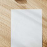 blank white paper sheet on wooden table